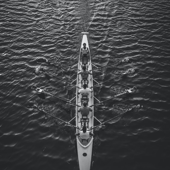 people riding boat on body of water